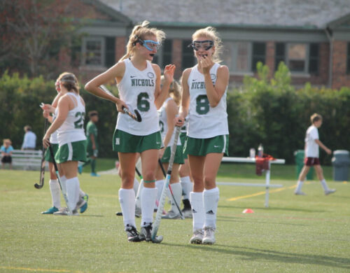 Emily and Lyla playing field hockey